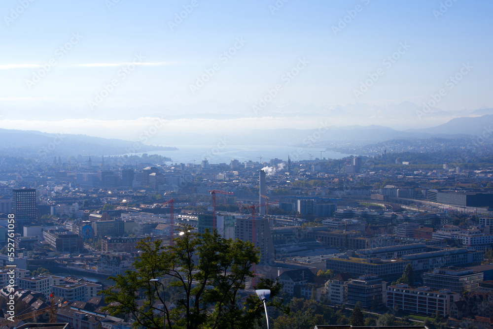 Aerial view of City of Zürich with skyscrapers Lake Zürich and Swiss Alps in the background on a sunny late summer day. Photo taken September 22nd, 2022, Zurich, Switzerland.