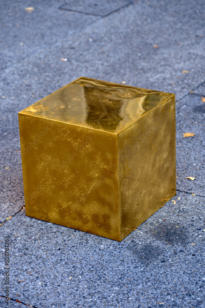 Close-up of art installation golden cube in public at City of Zürich from  German artist Niclas Castello on a late summer morning. Photo taken  September 22nd, 2022, Zurich, Switzerland. Photos | Adobe