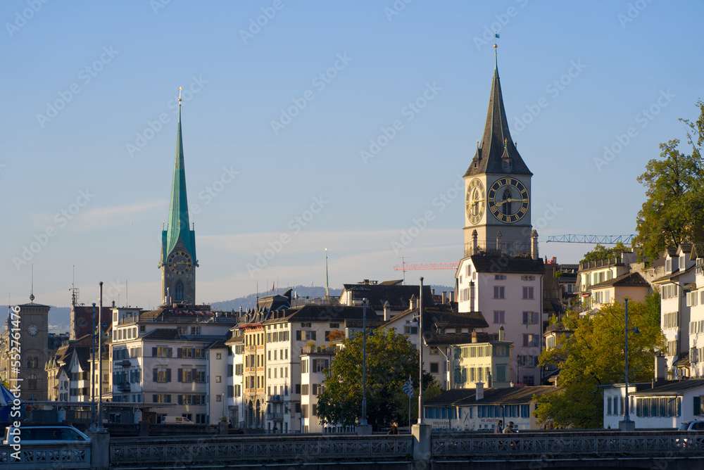 Beautiful cityscape of the old town of Zürich with church towers and Limmat River in the foreground on a sunny late summer morning. Photo taken September 22nd, 2022, Zurich, Switzerland.