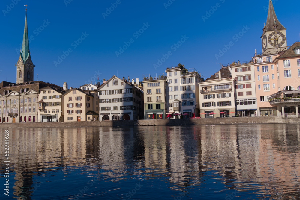 Beautiful cityscape of the old town of Zürich with Limmat River in the foreground with historic houses and bridge on a sunny late summer morning. Photo taken September 22nd, 2022, Zurich, Switzerland.