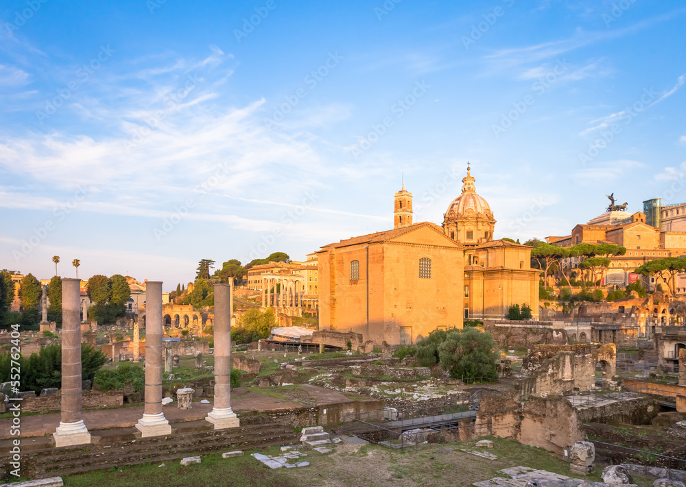 Sunrise light with blue sky on Roman ancient architecture in Rome, Italy