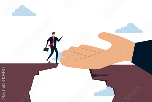 Helping hand support in career development, god hand reach to help or recuse businessman cross the cliffs.