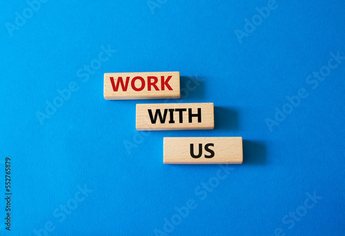 Work with us symbol. Wooden blocks with words Work with us. Beautiful blue background. Business and Work with us concept. Copy space.