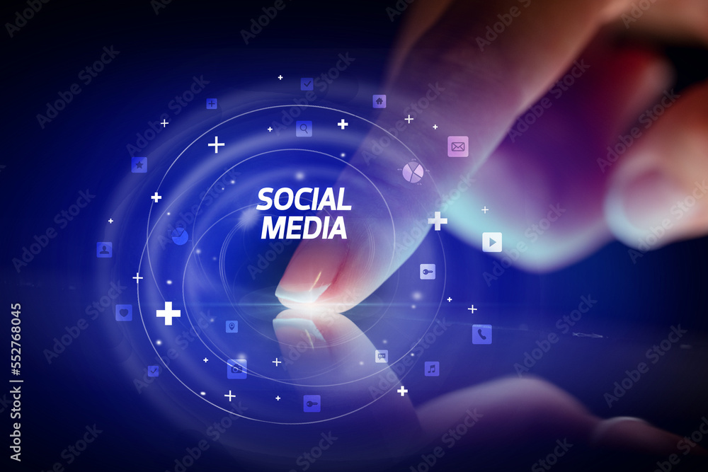 Finger touching tablet with social media icons concept Finger touching tablet with social media icons concept