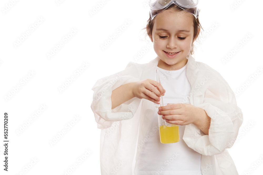 Details: child's hands mixing yellow liquid chemical solution in a measuring laboratory beaker, with glass stick at chemistry class, isolated on white background with copy space for your advertising Details: child's hands mixing yellow liquid chemical solution in a measuring laboratory beaker, with glass stick at chemistry class, isolated on white background with copy space for your advertising