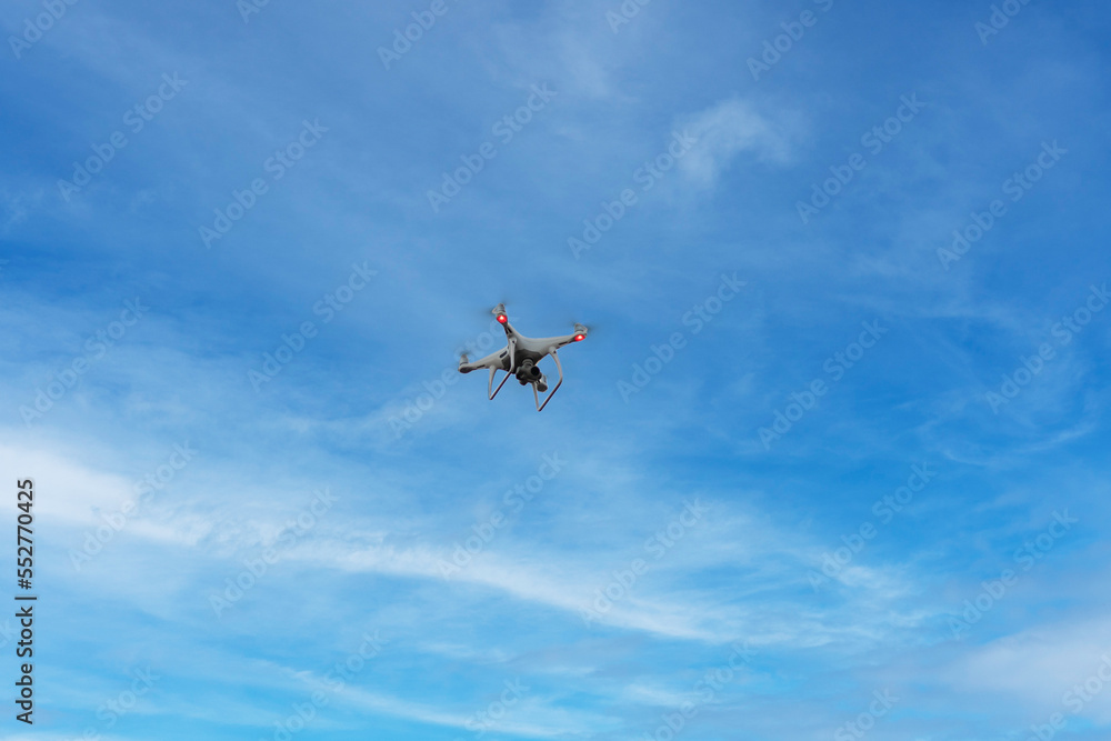 Drone in the sky, small quadrocopter flying, professional video gadget, digital photo equipment Drone in the sky, small quadrocopter flying, professional video gadget, digital photo equipment