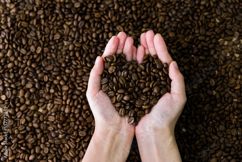 Coffee beans in hands of heart shaped