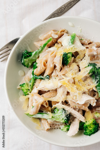Whole grain penne pasta with chicken and green vegetables.