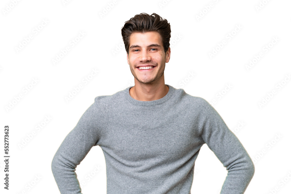 Fototapeta premium Young handsome caucasian man over isolated background posing with arms at hip and smiling
