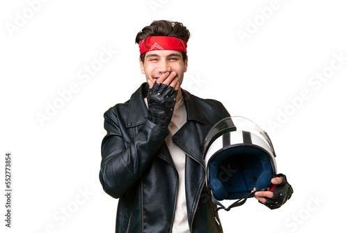 Young caucasian man with a motorcycle helmet over isolated background happy and smiling covering mouth with hand