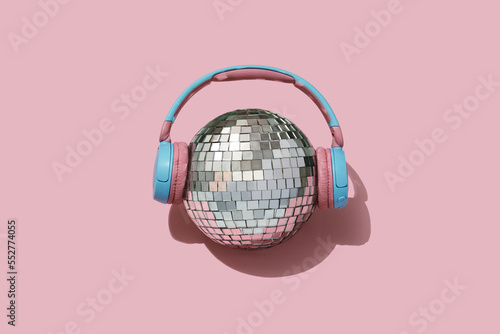 disco ball and headphones on pink backgournd. Concept for party and celebration