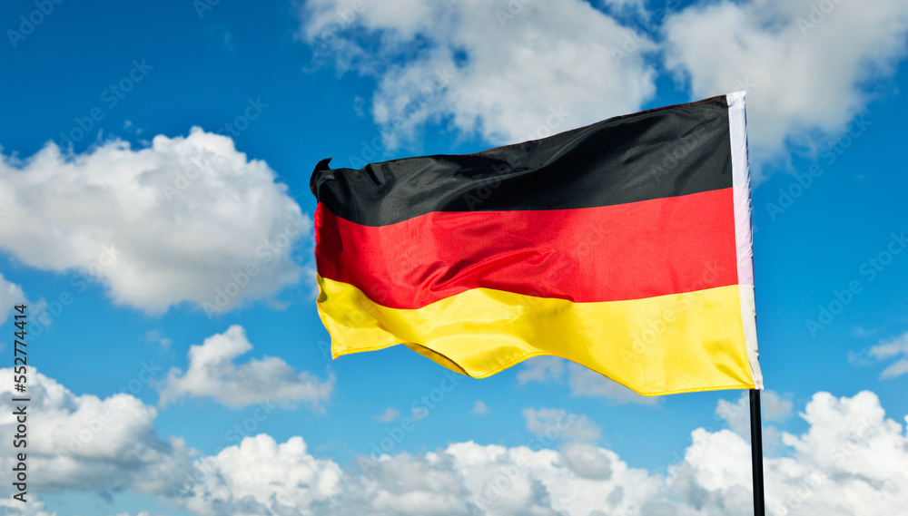 German flag waving against blue sky German flag waving against blue sky