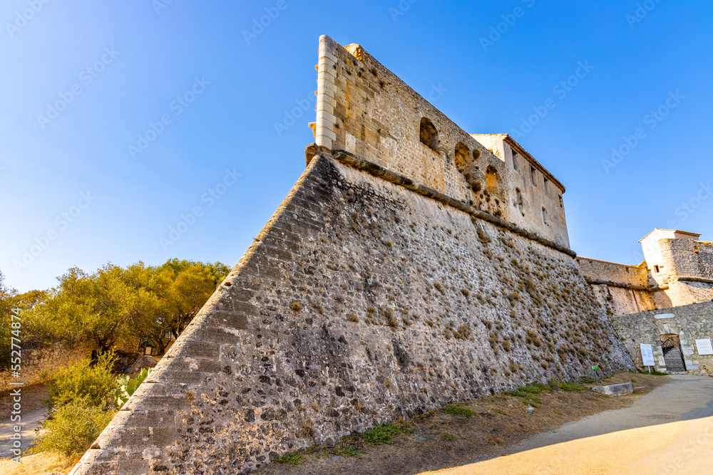 Defense walls and towers of medieval fortress Fort Carre castle in Antibes resort city onshore Azure Cost of Mediterranean Sea in France