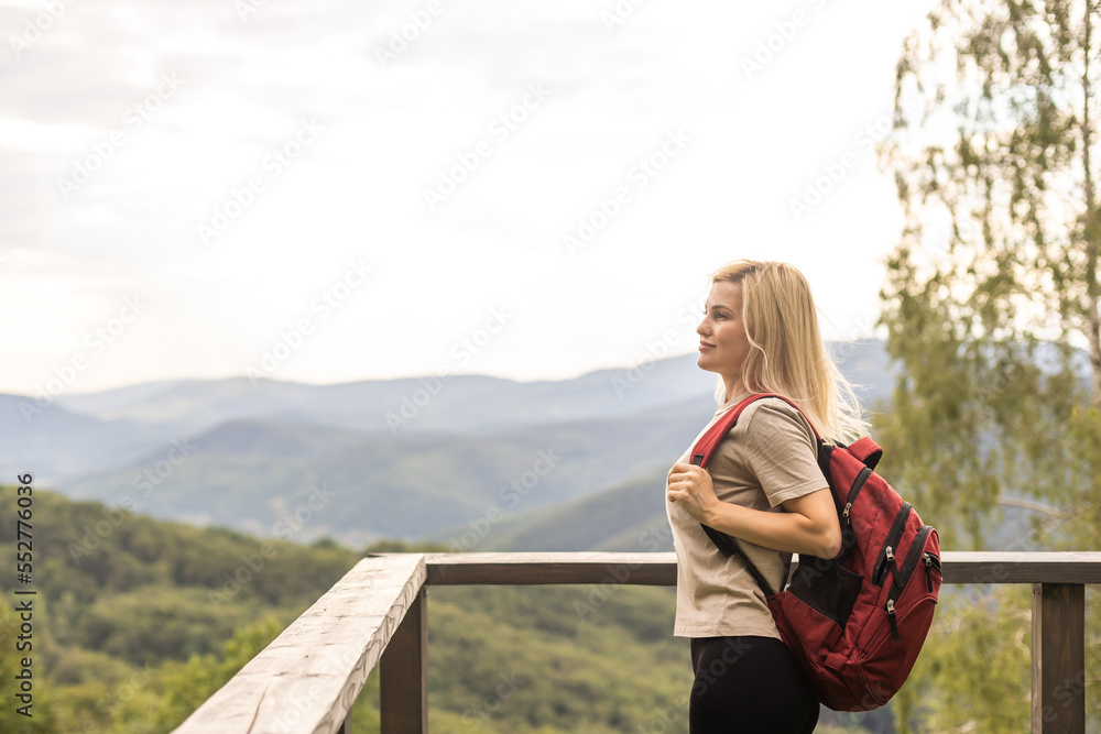Girl Traveler hiking with backpack at rocky mountains landscape Travel Lifestyle concept adventure summer vacations outdoor.