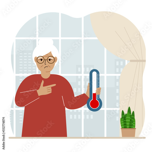 A woman near the window with a device for measuring the temperature in the room.