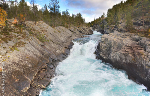 water of a straem flowing between the rocks in Norway © coco