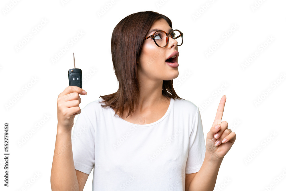Young Russian woman holding car keys over isolated chroma key background intending to realizes the solution while lifting a finger up Young Russian woman holding car keys over isolated chroma key background intending to realizes the solution while lifting a finger up