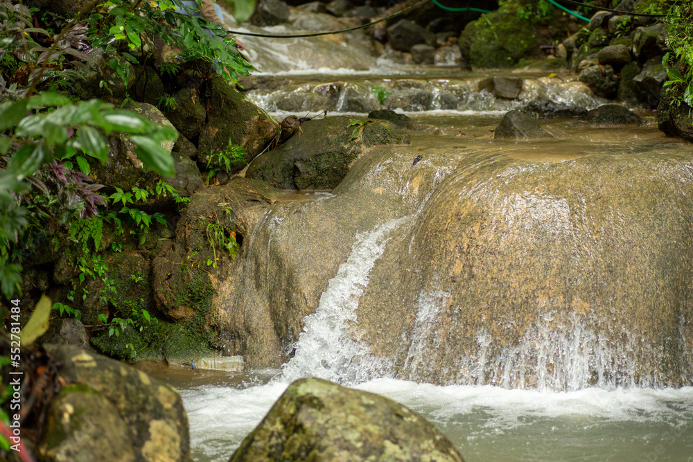 Fototapeta premium Enchanting waterfall with gentle flowing water on a big rock