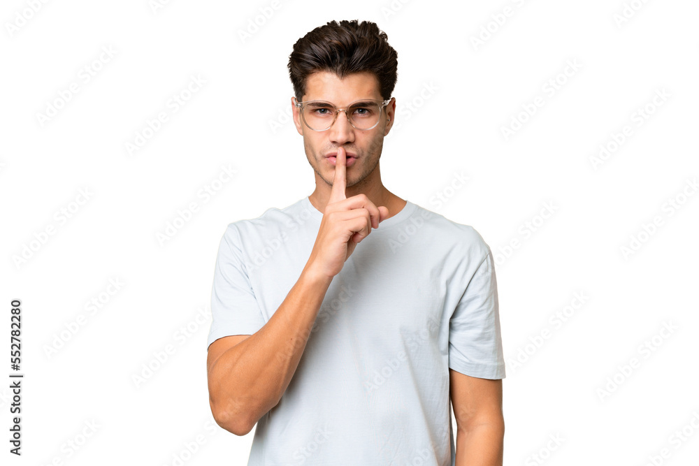 Young caucasian handsome man over isolated background showing a sign of silence gesture putting finger in mouth Young caucasian handsome man over isolated background showing a sign of silence gesture putting finger in mouth