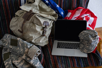 backpack and laptop against American flag. Military education