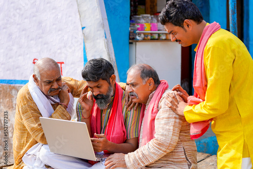 Indian farmer group giving shocking expression after see in laptop