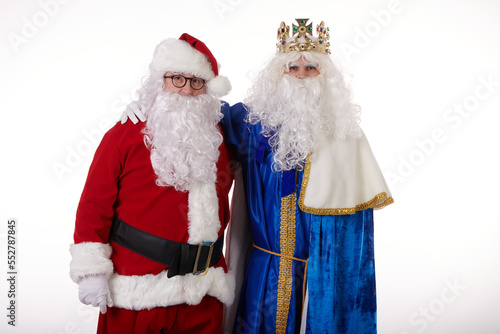 Wise Man and Santa Claus hugging as friends looking at the camera