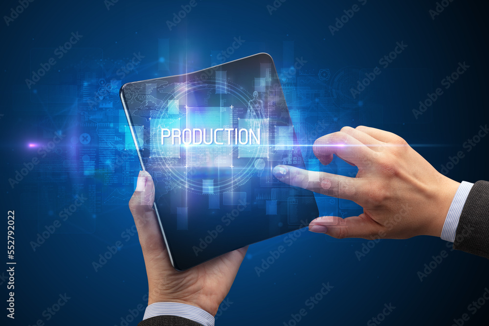 Businessman holding a foldable smartphone Businessman holding a foldable smartphone