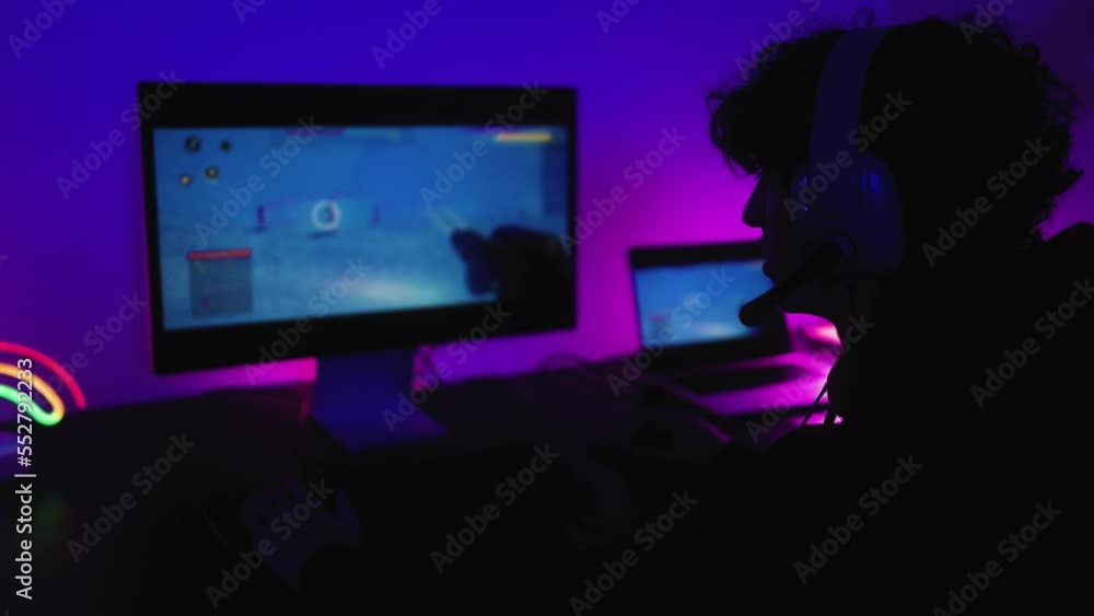 Young gamer having fun playing online video games with computer at home - Gaming entertainment and technology concept Young gamer having fun playing online video games with computer at home - Gaming entertainment and technology concept