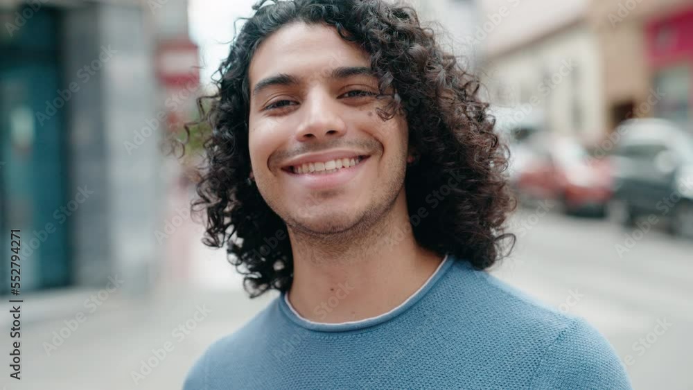 Young latin man smiling confident standing at street Young latin man smiling confident standing at street