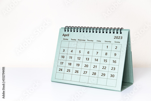 April 2023 calendar on white table. Month page