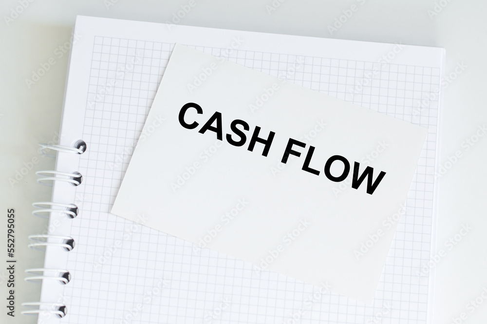 Business card with text Cash Flow on a white notebook on the table, business concept Business card with text Cash Flow on a white notebook on the table, business concept