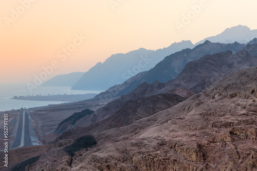 Sunset landscape with mountains along Red Sea coast disappearing into evening haze, Dahab, Egypt