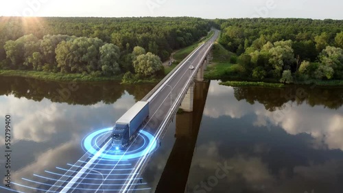 Autonomous semi-truck with a trailer, controlled by artificial intelligence, drives over a bridge over the river. Cargo delivery, transportation of the future. Artificial intelligence. Self driving