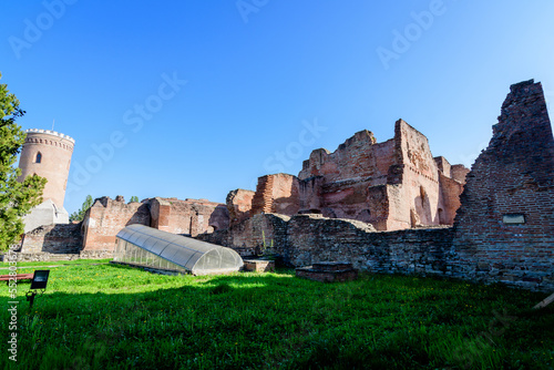 Old buildings and ruins at Targoviste Royal Court (Curtea Domneasca) in Chindia Park (Parcul Chindia) in the historical part of the city  in a sunny spring  day, in Romania photo