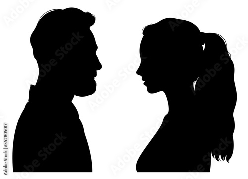Silhouettes of young attractive man and woman facing each other. Profile portrait of eye to eye couple.