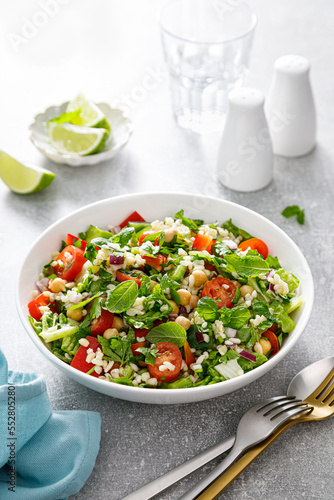 Tabbouleh salad. Tabouli salad with fresh parsley, onions, tomatoes, bulgur and chickpea. Healthy vegetarian food, mediterranean diet