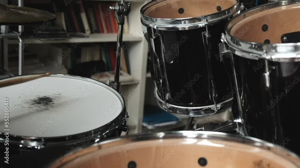 Man hands playing on drums with drumsticks. Musician during percussion musical instrument perfomance in recording studio Man hands playing on drums with drumsticks. Musician during percussion musical instrument perfomance in recording studio