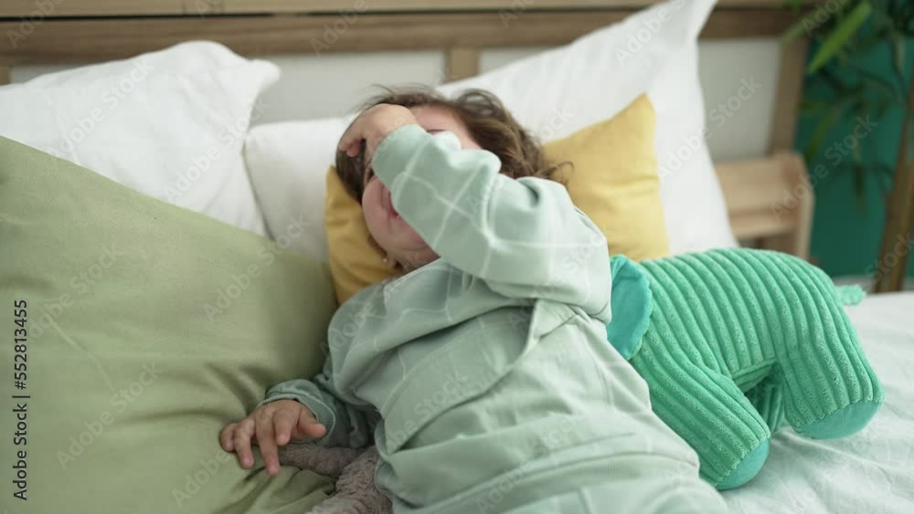 Adorable hispanic girl lying on bed crying at bedroom Adorable hispanic girl lying on bed crying at bedroom