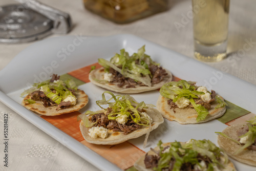 Close up of Chalupas, Typical Mexican dish made with tortillas, sauce, cheese, meat and lettuce.