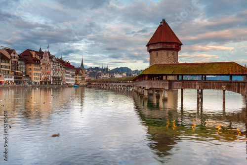 Ctyscape Lucerne Switzerland. Chapel Bridge across lake Lucerne with the Jesuit church on the banks of the lake. Landscape of amazing travel destination. © aroxopt