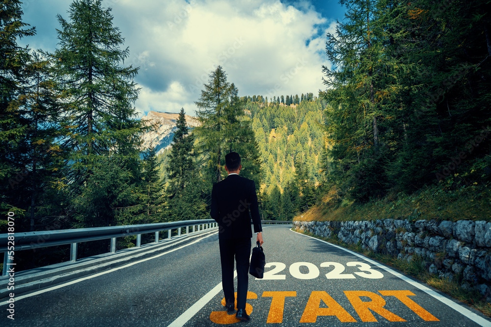 The 2023 New Year journey and future vision concept . Businessman traveling on highway road leading forward to happy new year celebration in beginning of 2021 for fresh and successful start . - obrazy, fototapety, plakaty 