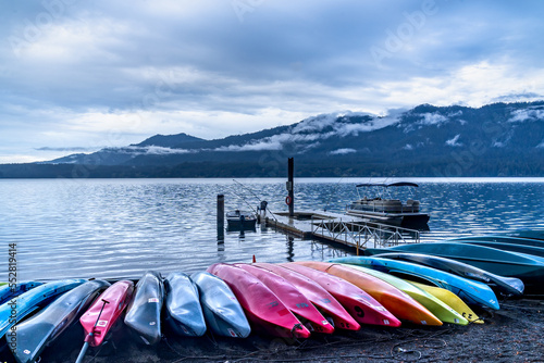 Quinault, WA - USA -Sept. 22, 2021: An overcast horizontal blue hour view of Lake Quinault Lodge's boat lined waterfront and dock on Lake Quinault in Olympic National Park. photo