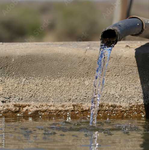 Lifegiving water from a borehole on a remote farm in the Northern Cape, South Africa photo