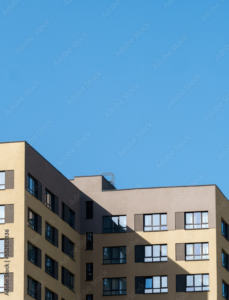 modern Scandinavian building. The bright facade of a multi-apartment building against a blue sky background.