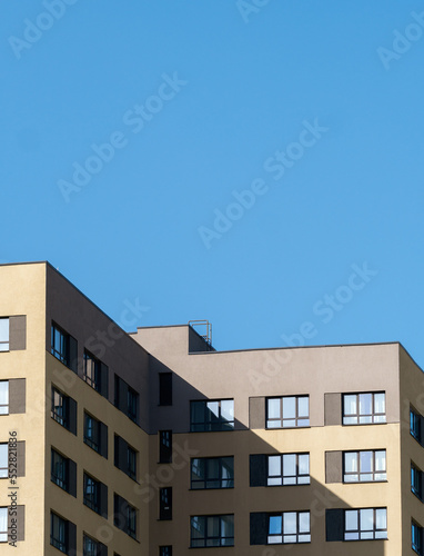modern Scandinavian building. The bright facade of a multi-apartment building against a blue sky background. © Artem Kudryavtsev