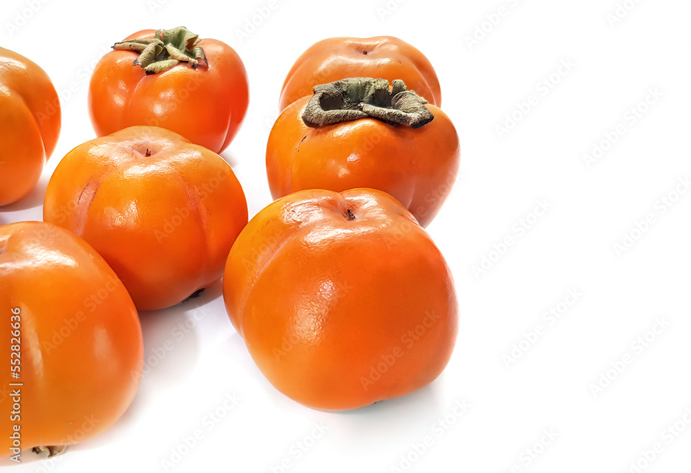 Persimmon. Group of a fresh ripe whole persimmon fruit with natural shadow on a white background Persimmon. Group of a fresh ripe whole persimmon fruit with natural shadow on a white background