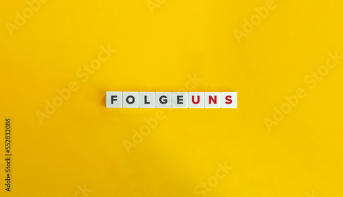 Folge Uns (Follow Us in German) Banner. Letter Tiles on Yellow Background. Minimal Aesthetics.