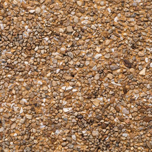 The pattern small brown pebbles stone as background. pebbles texture wall and floor.