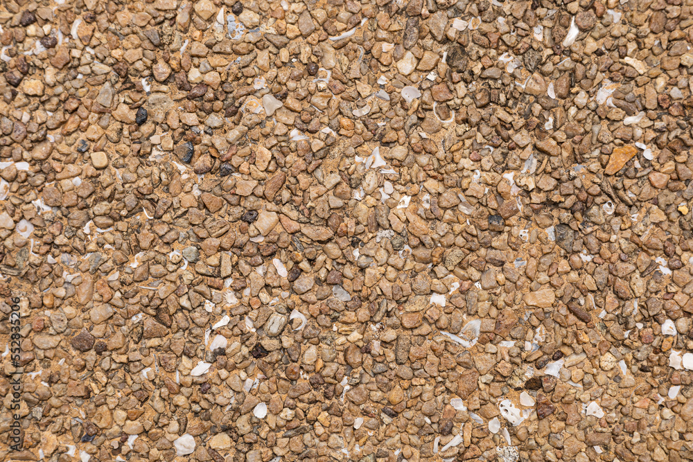 The pattern small brown pebbles stone as background. pebbles texture wall and floor. The pattern small brown pebbles stone as background. pebbles texture wall and floor.