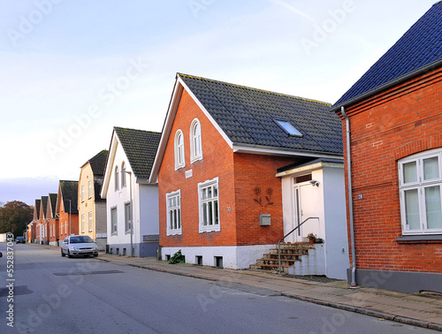Danish village street with typical brick houses in red and white photo